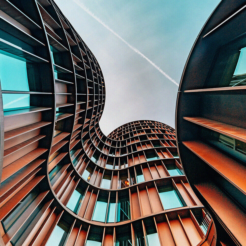 Architectural building with sweeping curves and rusted exterior facade