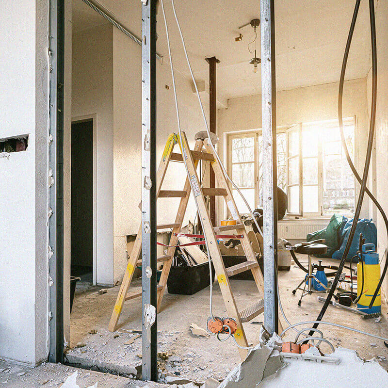 Property under renovation with exposed walls and construction tools scattered around