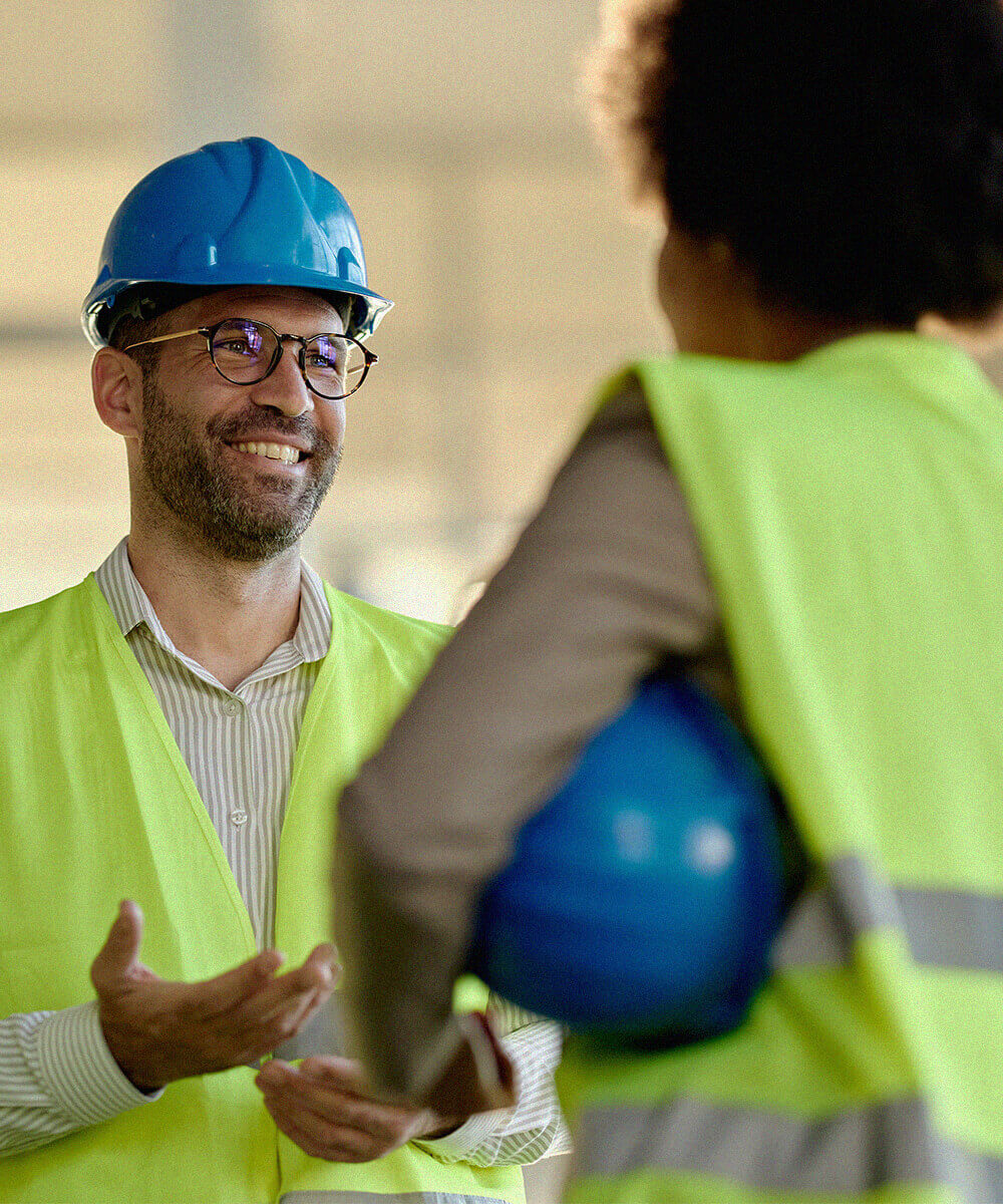 Developer wearing hard hat and high-visibility vest on construction site
