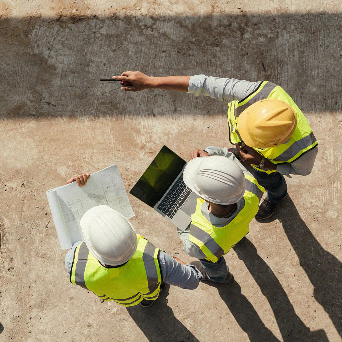 Construction workers making plans on a site